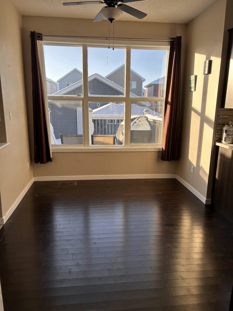 Finished dark hardwood in a dining nook with daylight from a large window